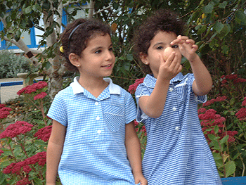 Image of two girls looking at an egg