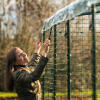 A woman attaching the cover to the walk in run