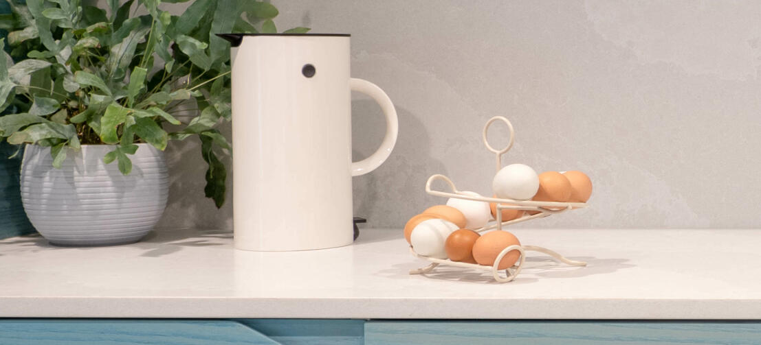 A cream Omlet egg skelter full of fresh eggs in a kitchen A cream Omlet egg skelter full of fresh eggs in a kitchen