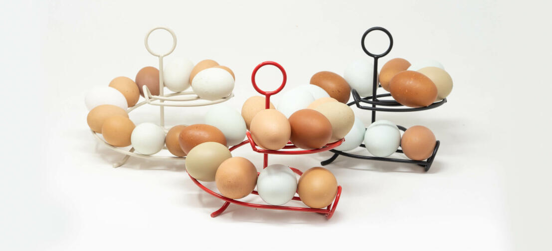 Three Omlet egg skelters full of fresh eggs in a kitchen Three Omlet egg skelters full of fresh eggs in a kitchen