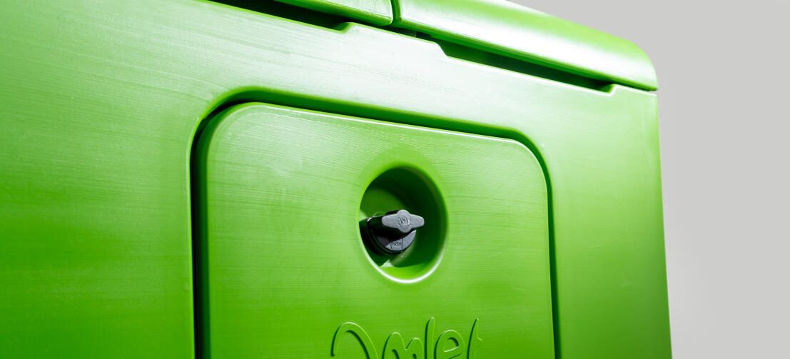 Close up of handle lock on eggport door on side of Eglu Cube chicken coop
