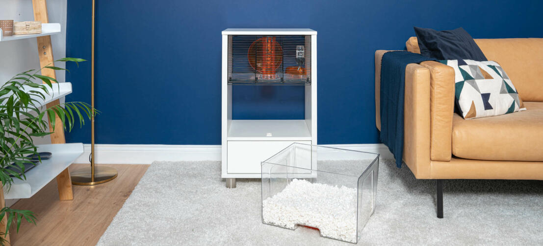 Modern white hamster Qute cage in a living room with bedding tray removed.