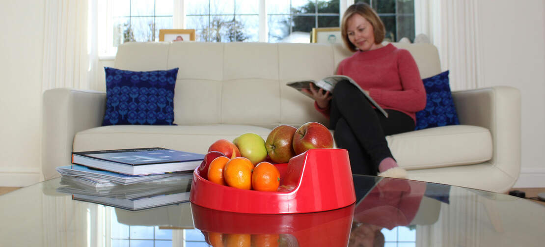 A red rollabowl fruit bowl in a home