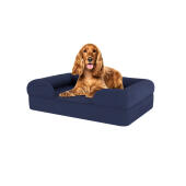 Dog sitting on medium midnight blue memory foam bolster dog bed