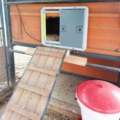 A grey automatic chicken coop door opener