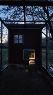 A coop light eluminating a chicken coop.