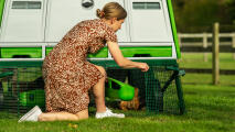 Woman accessing a coop run with handy doors