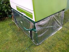A wind sheild clear cover around the bottom of a Cube chicken coop