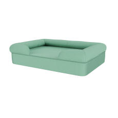 A bolster dog bed in teal blue.