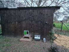 Door Omlet installed on a large wooden hen house. within 15 minutes, my hens were safe and i was relieved not to have to open and close the door.