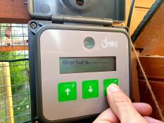 An open control panel of an automatic chicken coop door