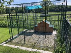 Wooden chicken coop inside of walk in chicken run