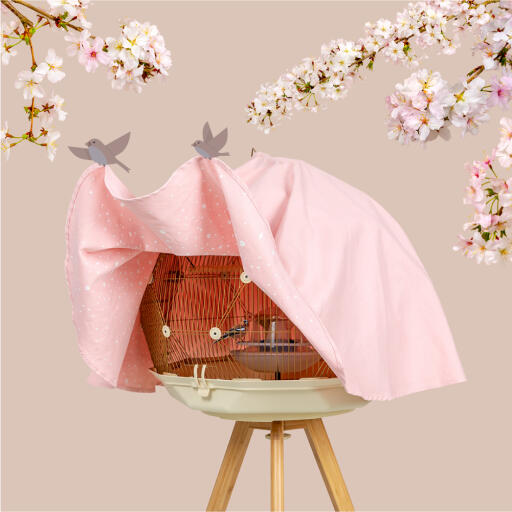 A pink cherry blossom cover for a Geo budgie bird cage