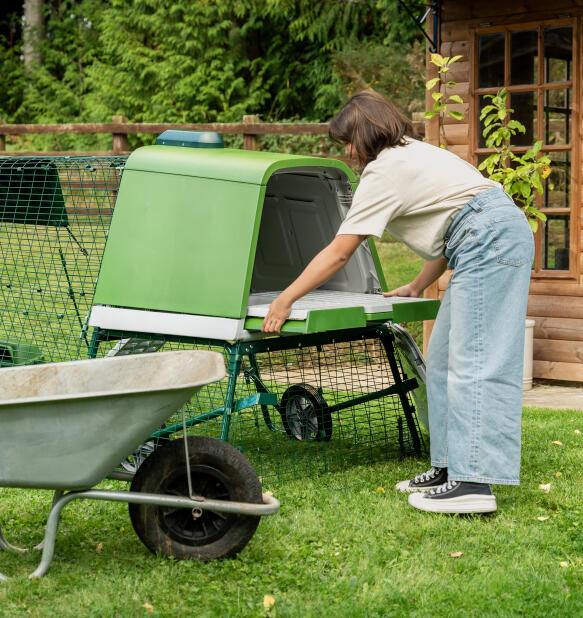 Woman pulling out the slide out dropping tray