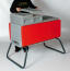 Person holding cover board for Beehaus with red Beehaus