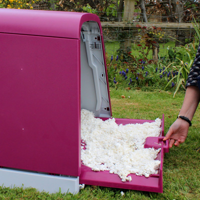 Bedding tray being removed from Eglu Go Hutch.